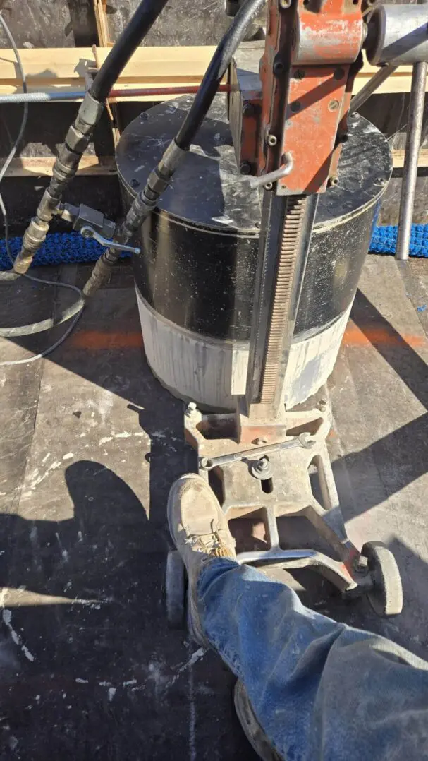 Concrete drilling machine in use on site.
