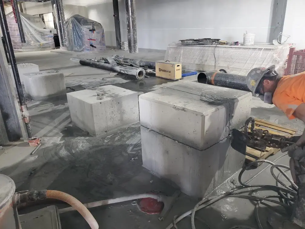 Construction site with concrete blocks and equipment.
