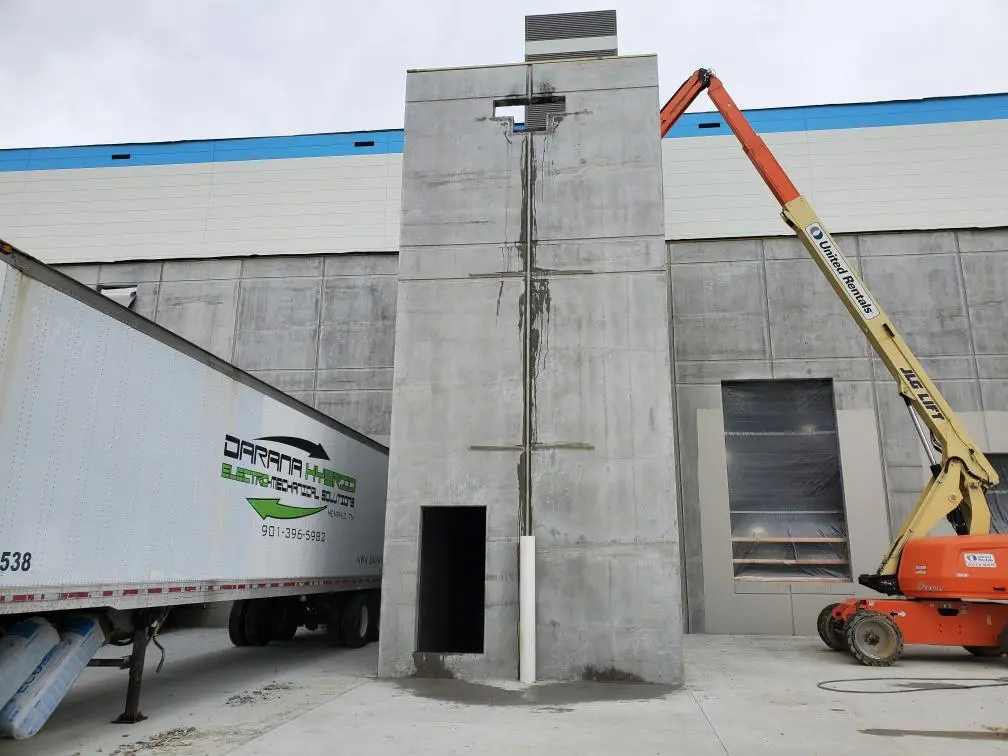 Construction site with crane and shipping container.