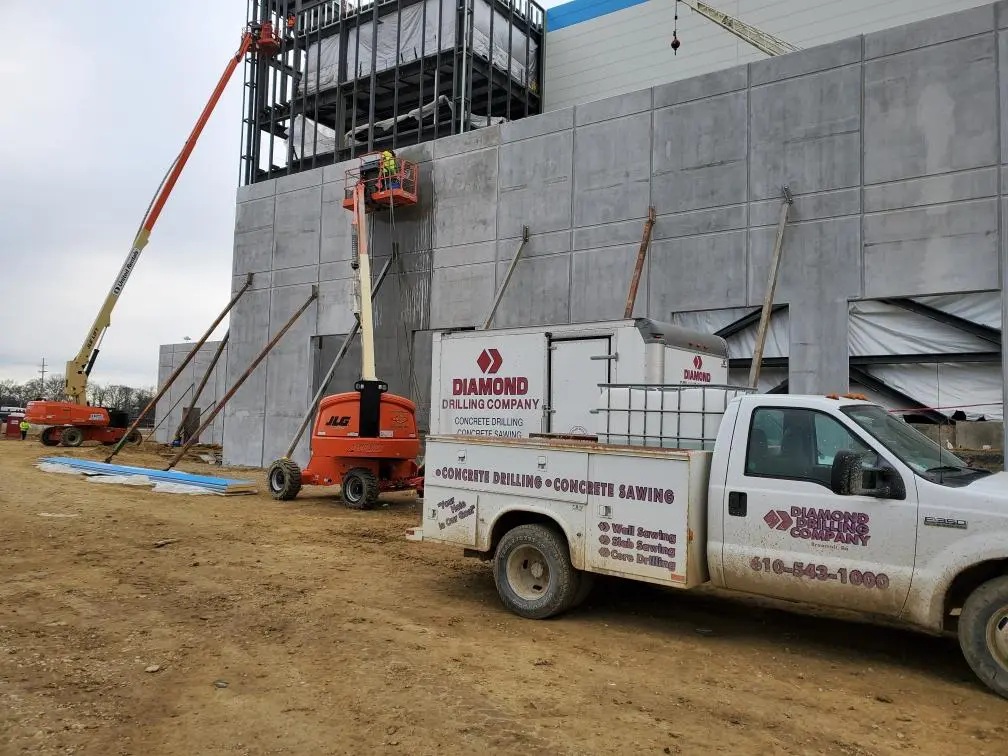 Construction site with trucks and cranes.